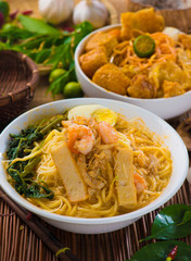 Prawn Laksa soup with rice noodles, shrimps garnished with fresh
