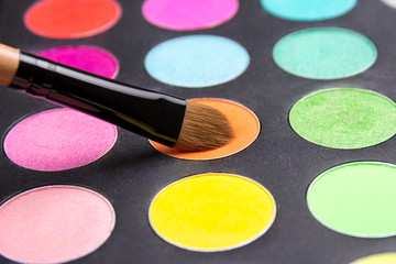 Make-up brush and eyeshadow palette close up
