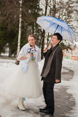 The bride and groom in the park in winter