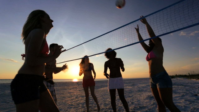 College Friends Laughing Enjoying Sunset Beach Volleyball