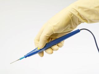 surgeon holding a blue electric scalpel