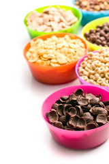 various sweet cereals in colorful bowls