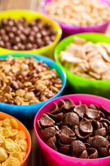 various cereals in colorful bowls