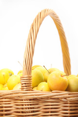 yellow apples in a wicker basket
