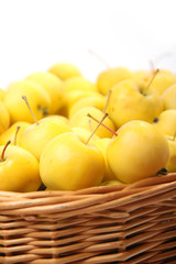 yellow apples in a wicker basket