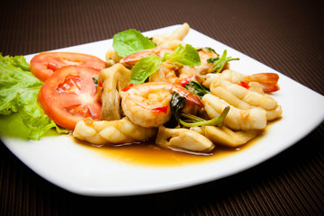 Spicy fried squid and shrimp with basil leaves Thai food