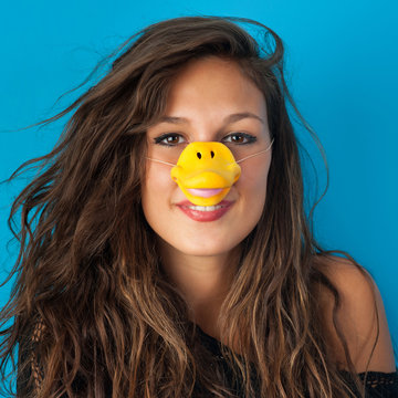 Funny portrait of young woman wit duck mask.
