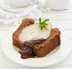 Chocolate cake with pears and chocolate sauce.
