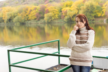 Beautiful young woman alongside a river