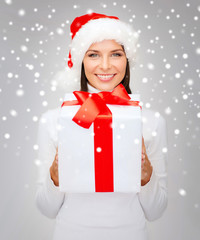 smiling woman in santa helper hat with gift box