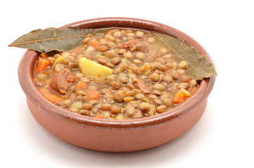 Brown lentil stew in bowl with vegetable