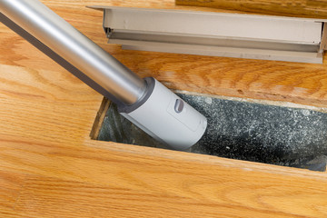 Cleaning inside heating floor vent with Vacuum Cleaner - 56956398