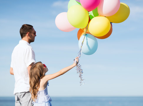 father and daughter with colorful balloons