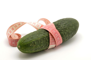 Cucumber and measuring tape isolated on white