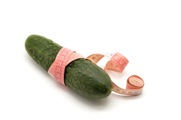 Cucumber and measuring tape isolated on white