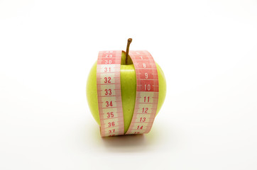 Green apple and measuring tape isolated on white