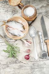 Two roaches fish in ceramic bowl with salt.