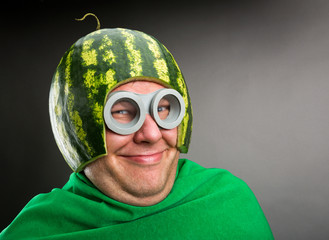 Funny man with watermelon helmet and googles