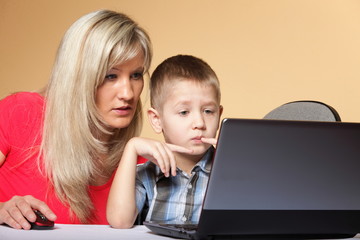 mother with son looking on the laptop