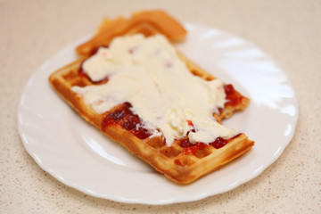 Belgian waffle with jam and whipped cream