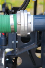 green plastic hose tube is connected to blue steel pipeline