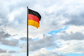 German flag with cloudy sky