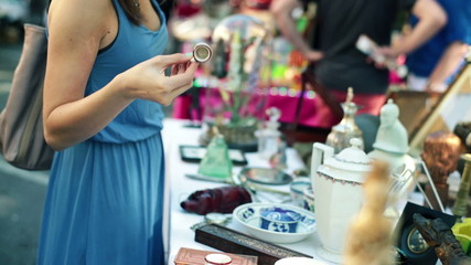 Young beautiful woman on flea market