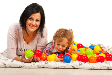 Fototapeta na wymiar Mother and son having fun with balls