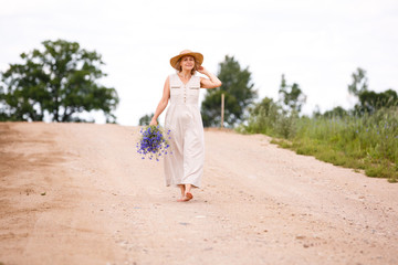 Fototapeta na wymiar Women on country road with flowers