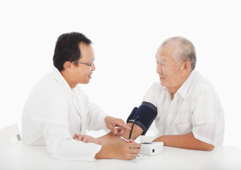 doctor measuring blood pressure of male patient