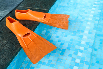 Orange Rubber flippers in pool