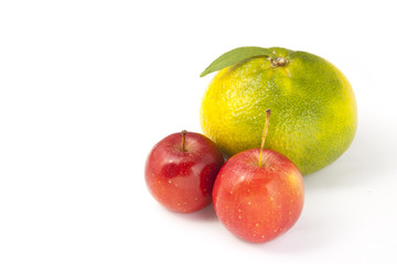 small apples and a big orange