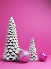 White Christmas trees and pink baubles festive decorations