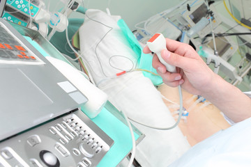 doctor makes ultrasound study in hospital ward.