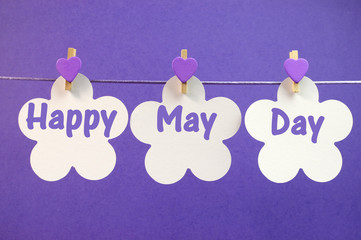 Happy May Day greeting message pegs on a line