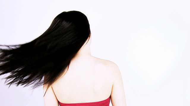 Woman undoing long ponytail smiling