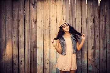 Fototapeta premium young beautiful girl on background wooden wall