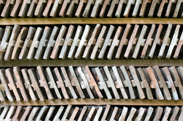  Close up on two rows of arranged bricks on a wood shelf. 