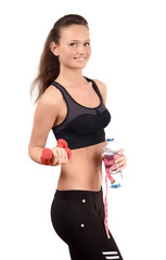 Fit girl with dumbbells,a bottle of water with a measuring tape