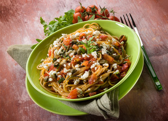 spaghetti with tomatoes cheese capers and arugula