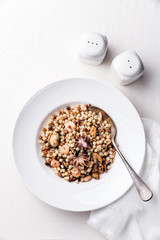Pasta fregula sarda with seafood on white plate