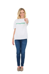 Fototapeta premium Smiling blonde volunteer pointing at camera