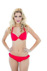 Obraz premium Attractive blonde model posing with hands on hips wearing bikini