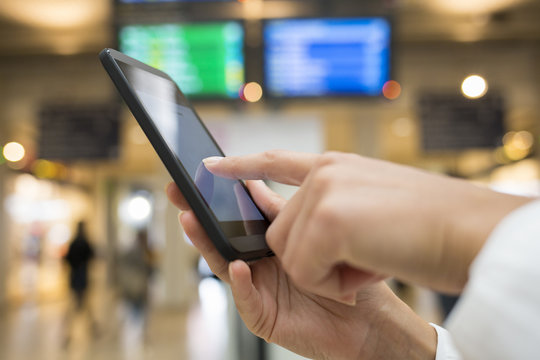 Close up of hands woman using her cell phone in station, backgro