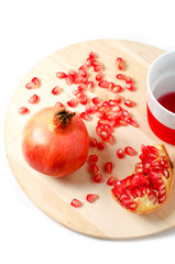 Fresh ripe pomegranate and juice in the small cup