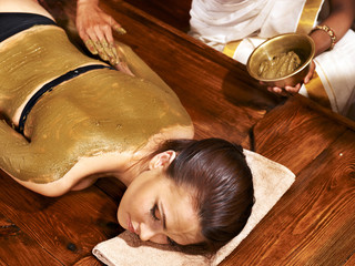 Woman having Ayurvedic body  spa massage.