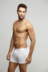 Fototapeta premium Portrait of mid adult man in underpants, studio shot