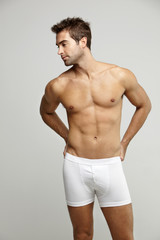 Fototapeta premium Mid adult man in underpants looking away, studio shotv