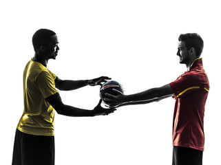 two men soccer player giving football  silhouette