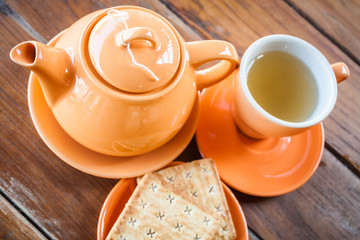 Hot teapot with cup and crackers